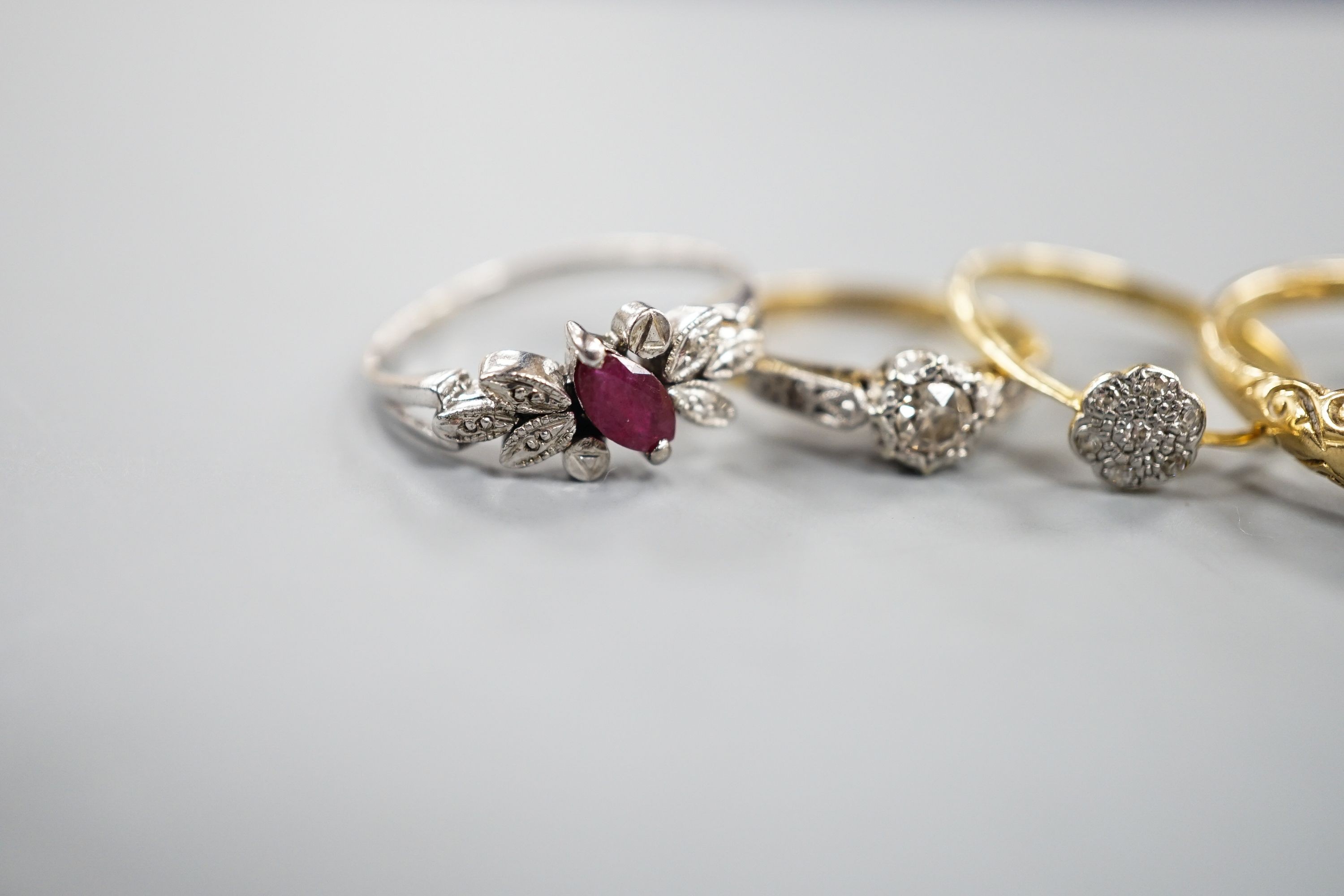 Two 18ct and diamond rings, including small cluster and single stone, sizes L & H, an 18ct sapphire and diamond ring, size O, gross 7.3 grams and two other yellow or white metal and gem set rings, gross 3.6 grams.
